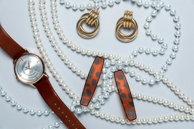 Photo of Flat lay composition with jewelry and watch on light grey background