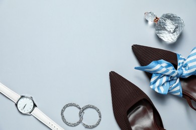 Photo of Flat lay composition with jewelry, accessories and shoes on light grey background. space for text