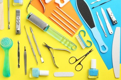 Photo of Set of pedicure tools on color background, flat lay