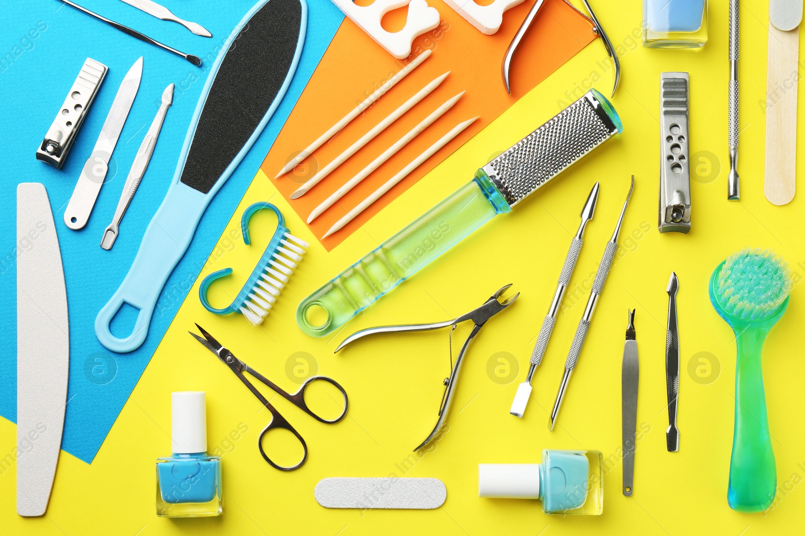 Photo of Set of pedicure tools on color background, flat lay