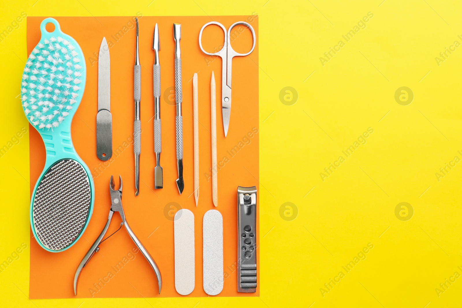 Photo of Set of pedicure tools on color background, flat lay. Space for text