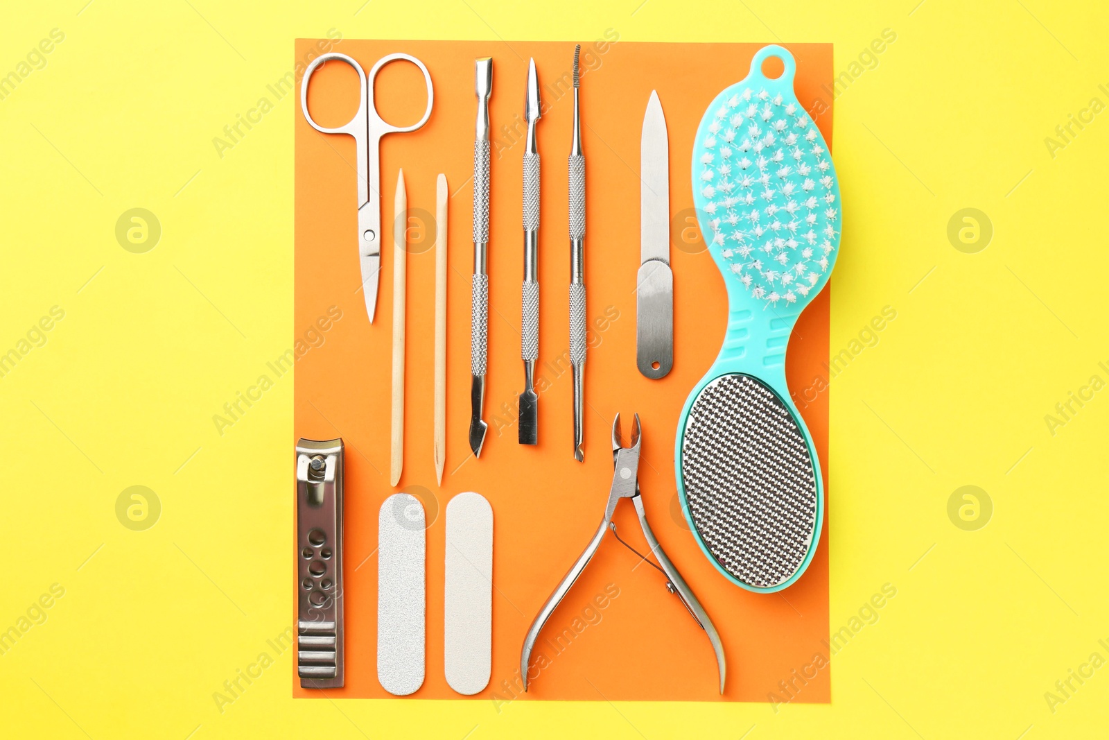 Photo of Set of pedicure tools on color background, flat lay