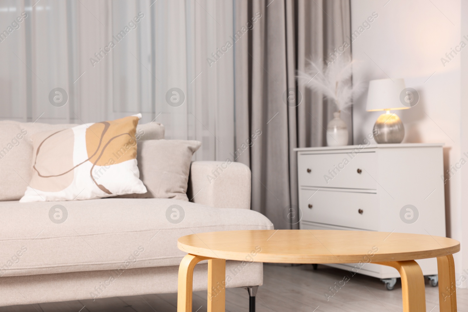 Photo of Wooden coffee table and other furniture in room. Interior design