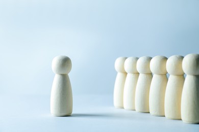 Photo of Human resources concept. Many wooden figures on light background, closeup