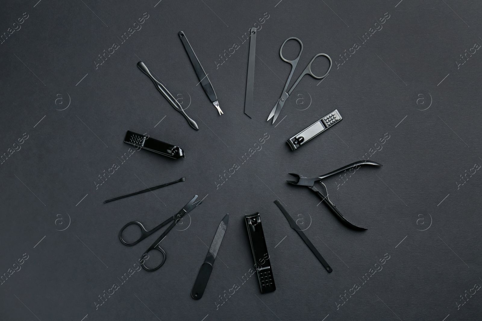 Photo of Set of pedicure tools on black background, flat lay