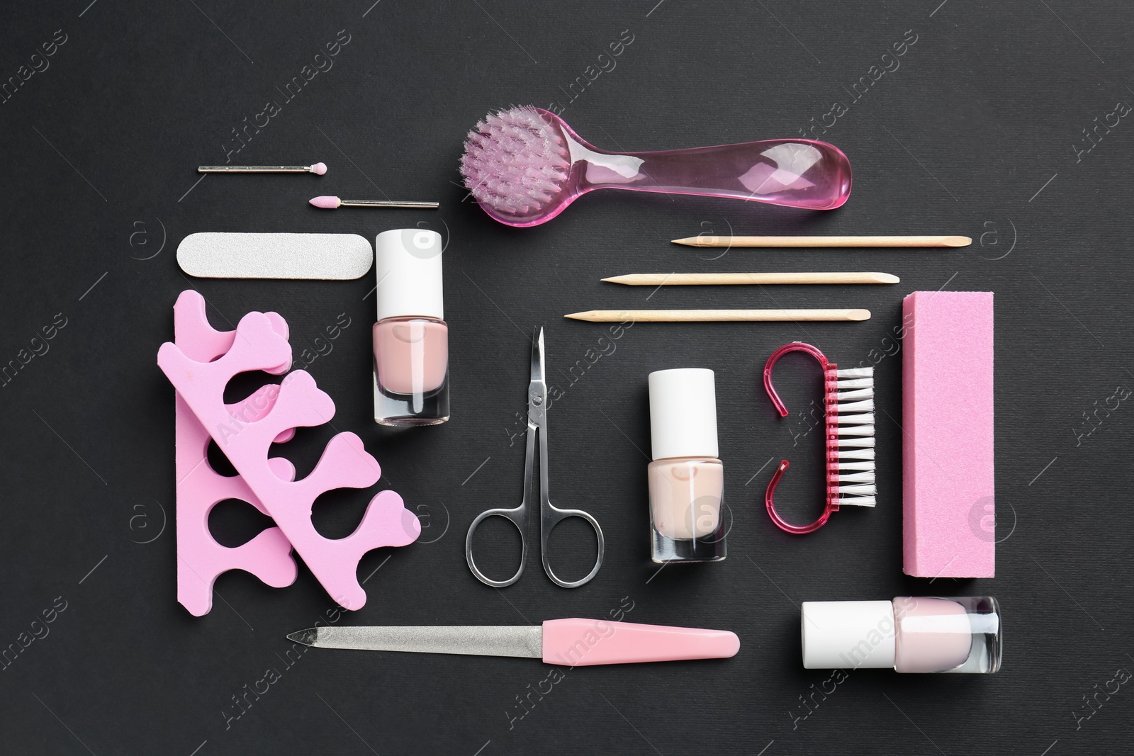 Photo of Set of pedicure tools on black background, flat lay