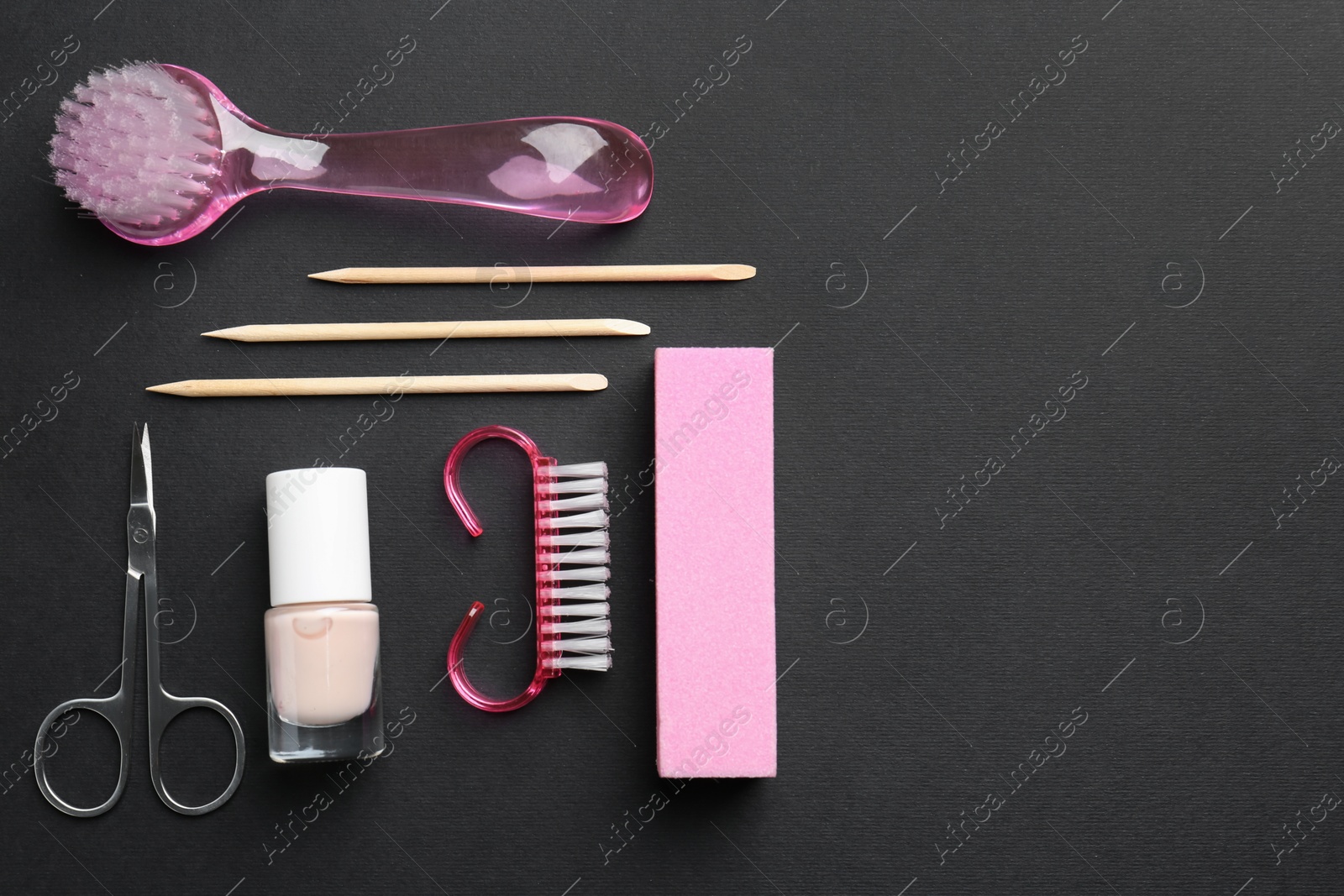 Photo of Set of pedicure tools on black background, flat lay. Space for text