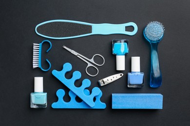 Photo of Set of pedicure tools on black background, flat lay