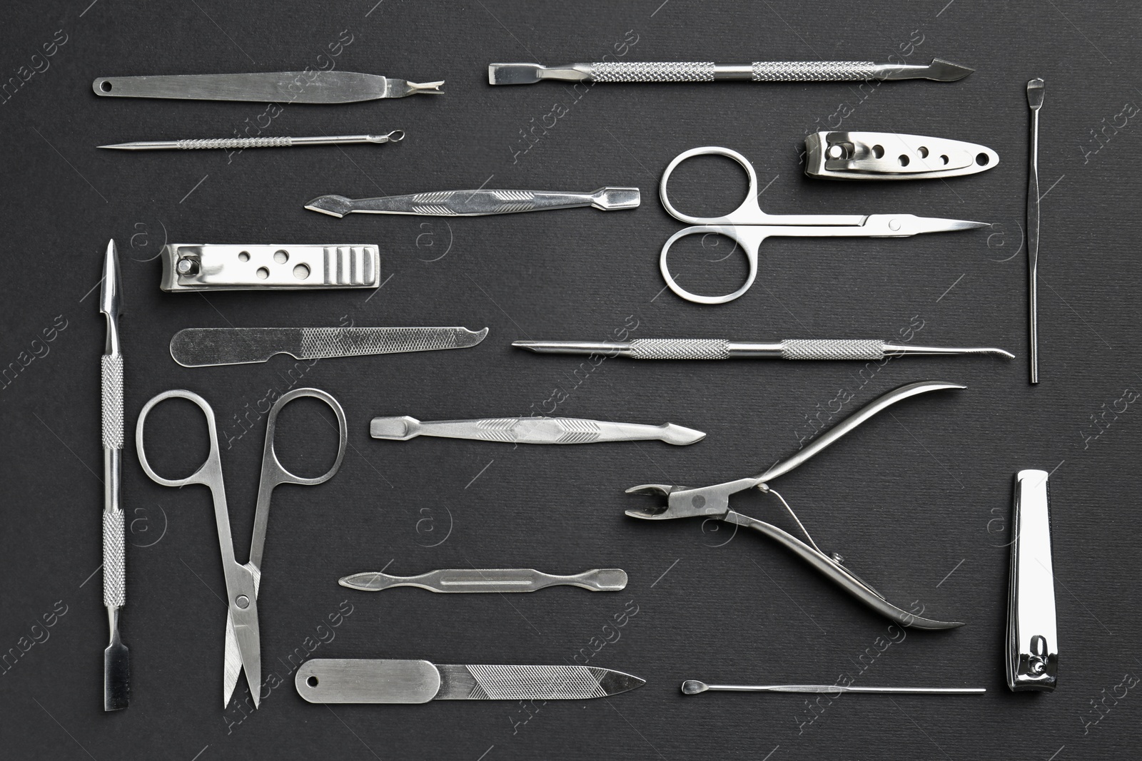 Photo of Set of pedicure tools on black background, flat lay