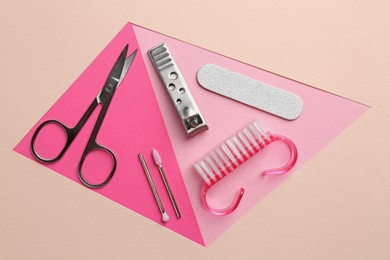 Photo of Set of pedicure tools on color background, flat lay