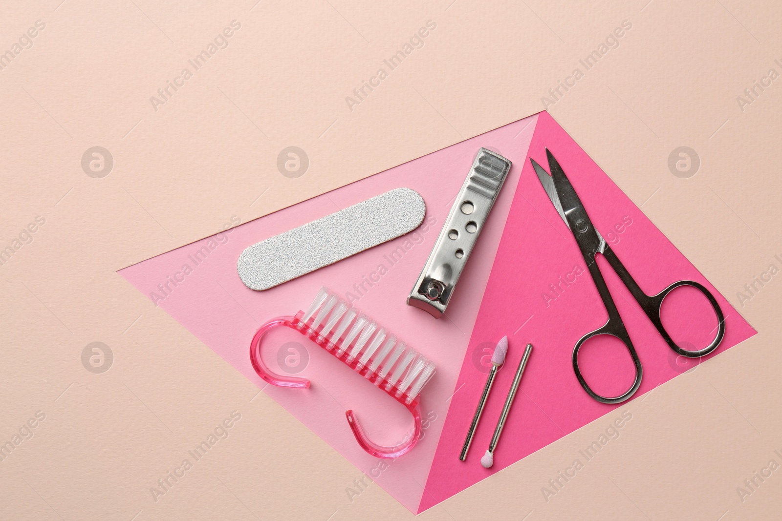 Photo of Set of pedicure tools on color background, flat lay