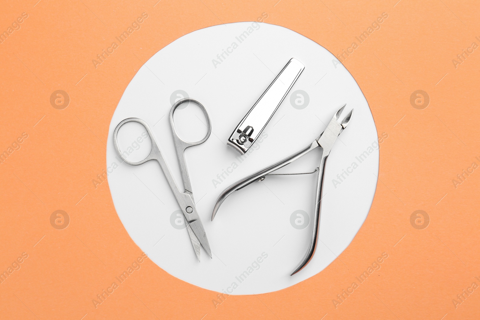 Photo of Set of pedicure tools on color background, flat lay