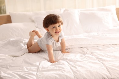 Photo of Cute little boy in bed at home, space for text