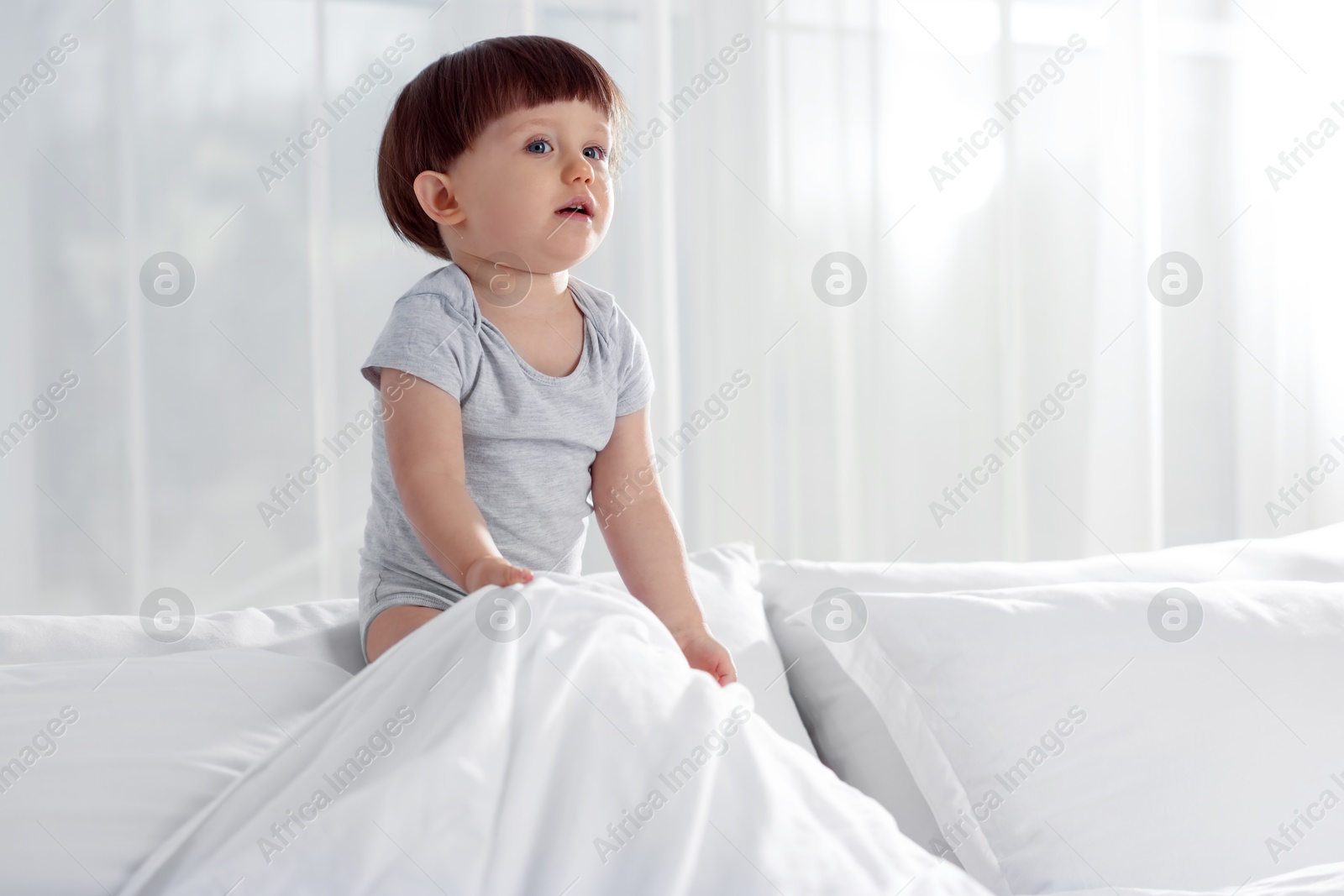 Photo of Cute little boy in bed at home, space for text