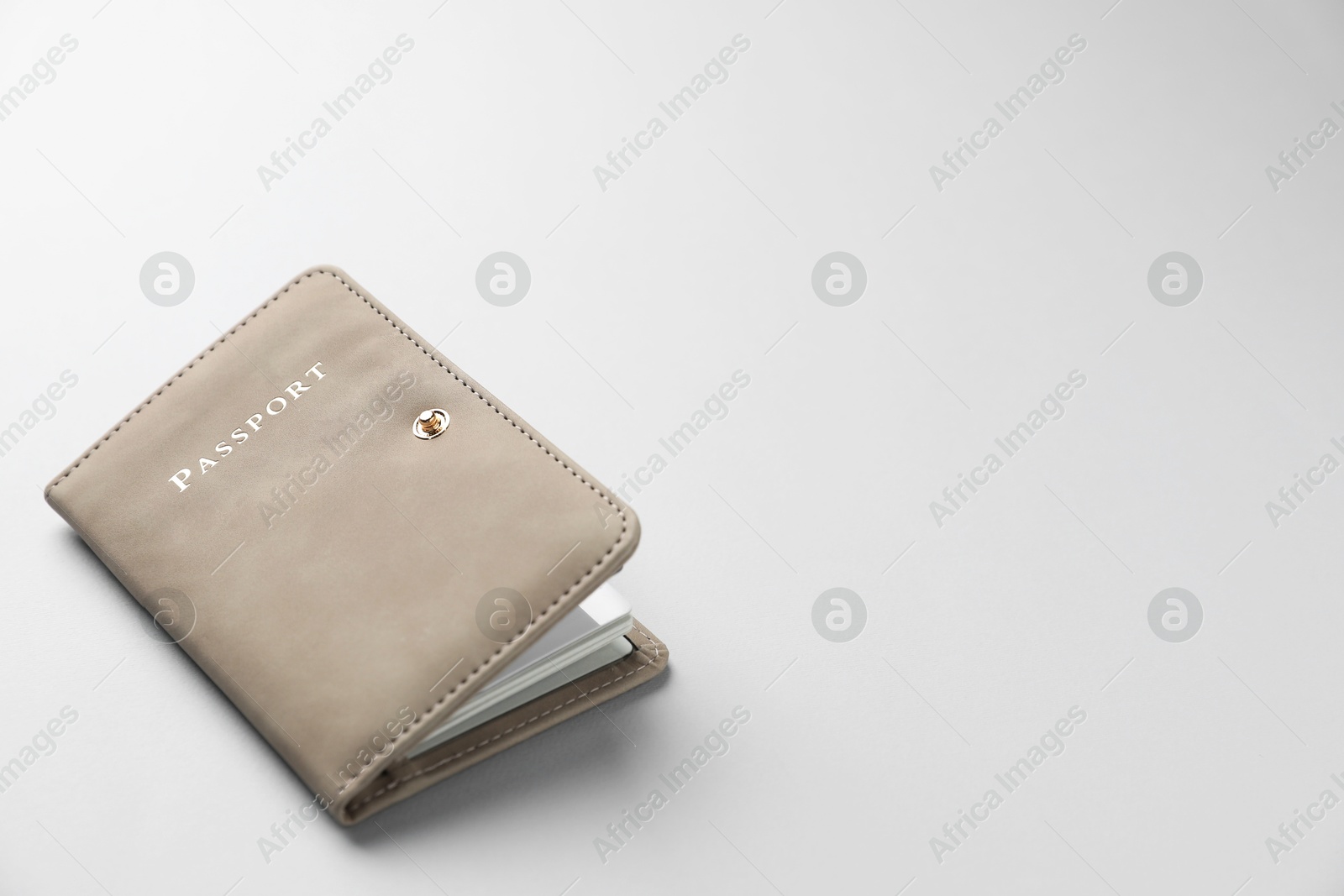 Photo of Passport in bright cover on grey background, closeup. Space for text