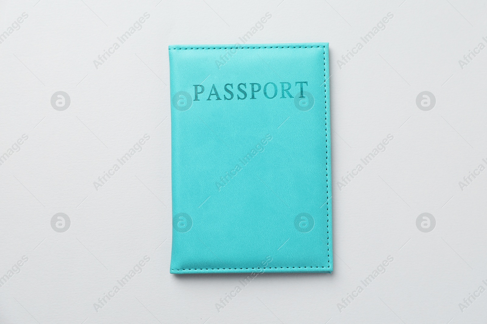 Photo of Passport in bright cover on grey background, top view