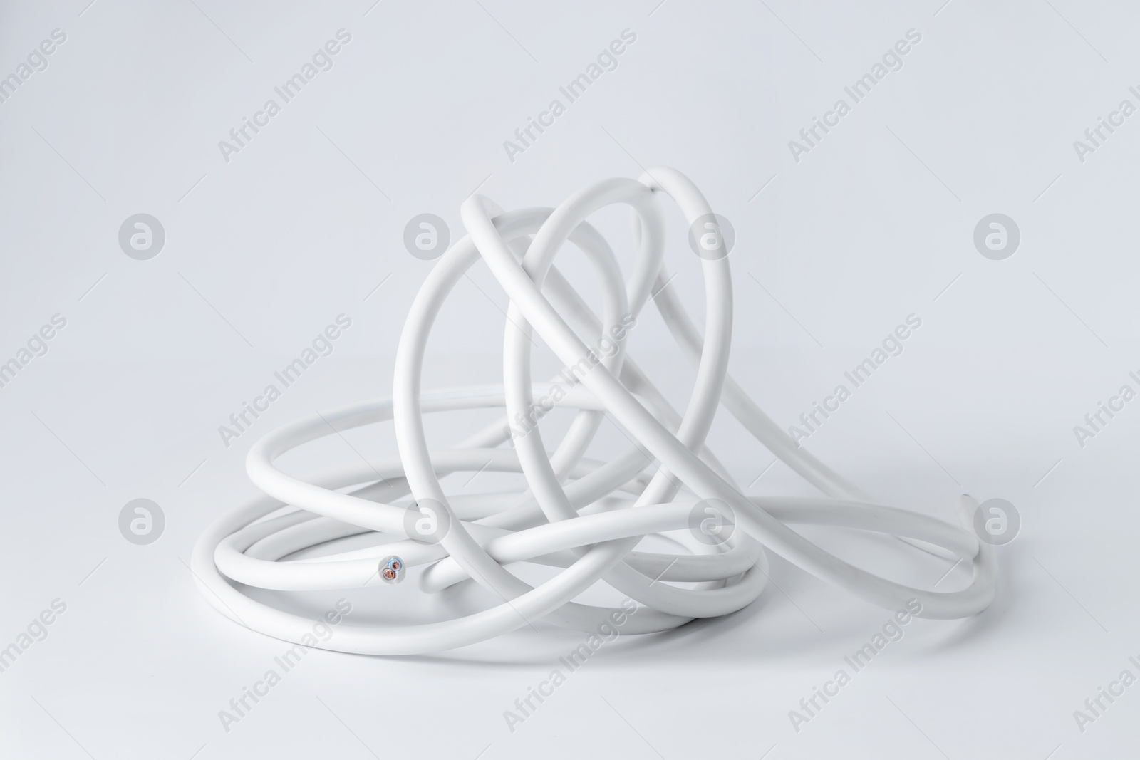 Photo of Tangled insulated electrical wire isolated on white