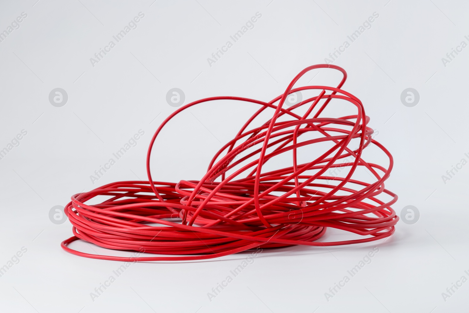 Photo of Insulated red electrical wire isolated on white