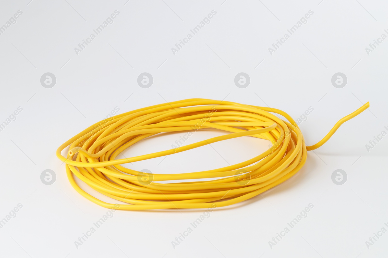 Photo of Insulated yellow electrical wire isolated on white