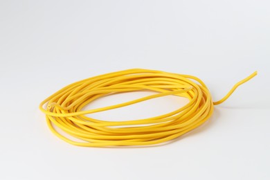 Photo of Insulated yellow electrical wire isolated on white