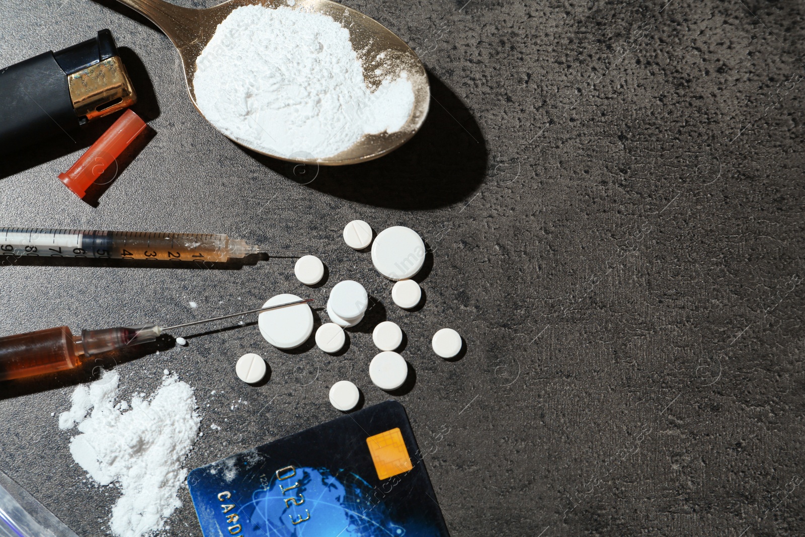 Photo of Flat lay composition with different drugs on gray textured table, space for text