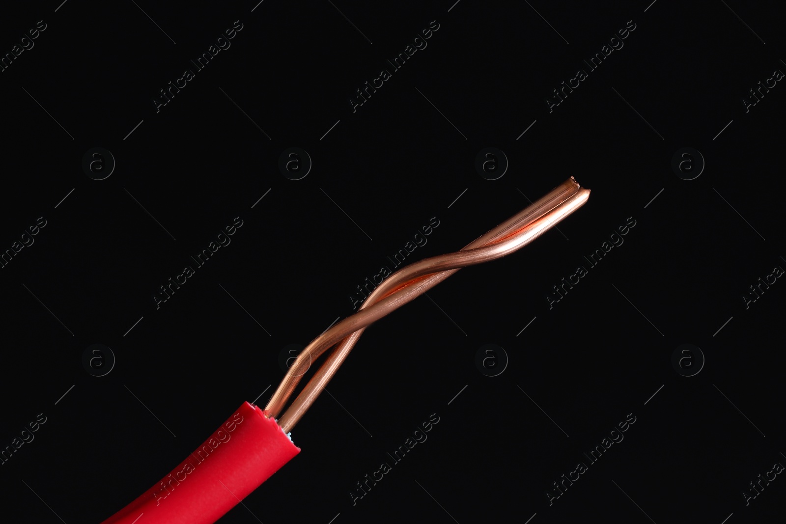 Photo of Red stripped electrical wire on black background, closeup