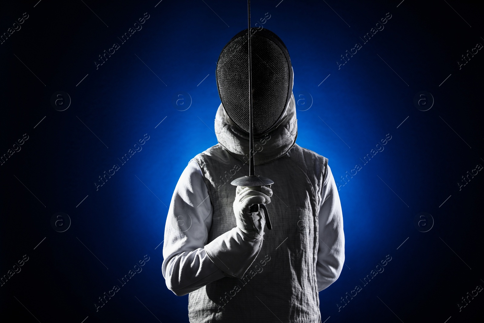 Photo of Fencer with epee on dark blue background