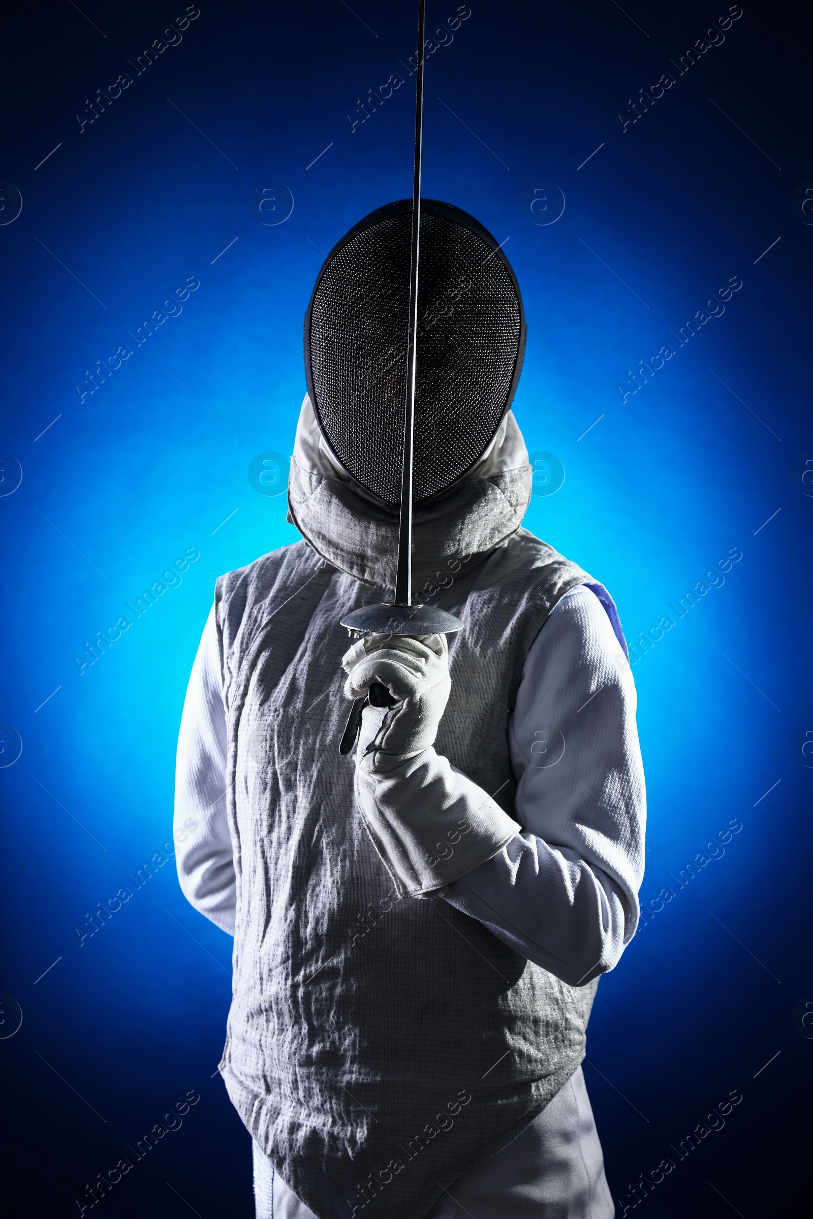 Photo of Fencer with epee on dark blue background