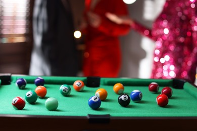 Photo of Many colorful billiard balls on green table indoors, space for text