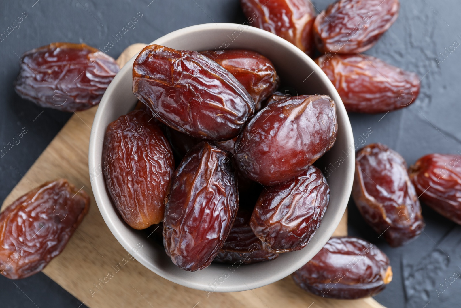 Photo of Tasty dried dates on grey table, top view