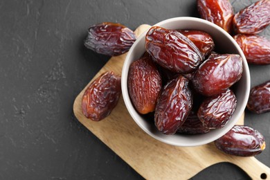 Photo of Tasty dried dates on grey table, top view