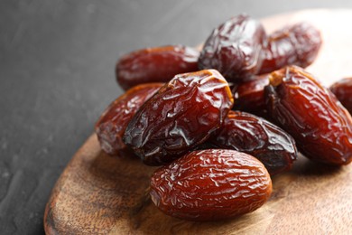 Photo of Tasty dried dates on grey table, closeup