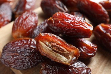 Photo of Many tasty dried dates on table, closeup