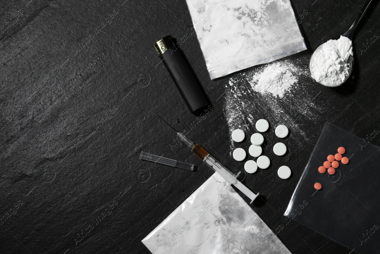 Photo of Flat lay composition with different drugs on black textured table, space for text