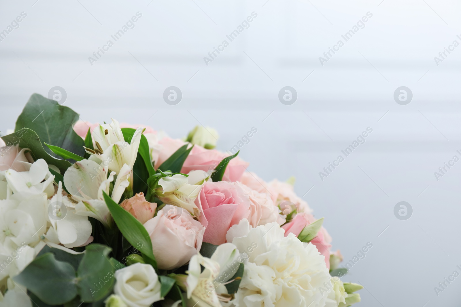 Photo of Beautiful bouquet on light background, closeup. Space for text