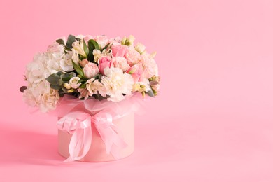 Photo of Bouquet of beautiful flowers on pink background, space for text