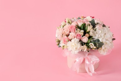 Photo of Bouquet of beautiful flowers on pink background, space for text