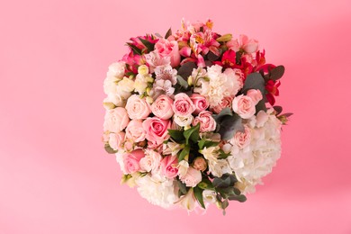 Photo of Bouquet of beautiful flowers on pink background, top view. Space for text