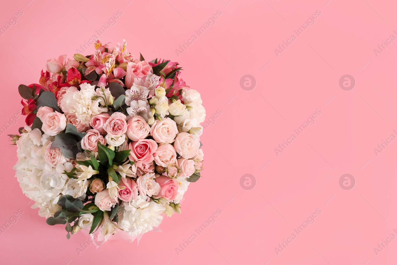 Photo of Bouquet of beautiful flowers on pink background, top view. Space for text