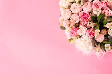 Photo of Bouquet of beautiful flowers on pink background, top view. Space for text