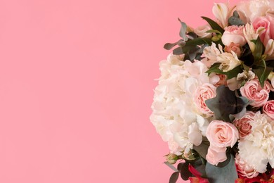 Photo of Bouquet of beautiful flowers on pink background, top view. Space for text