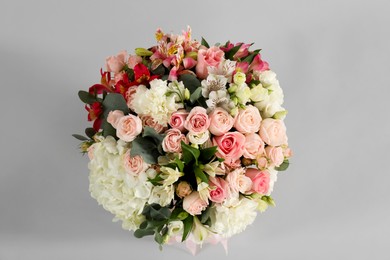 Photo of Bouquet of beautiful flowers on grey background, top view