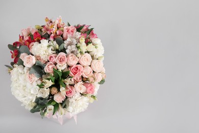 Photo of Bouquet of beautiful flowers on grey background, top view. Space for text