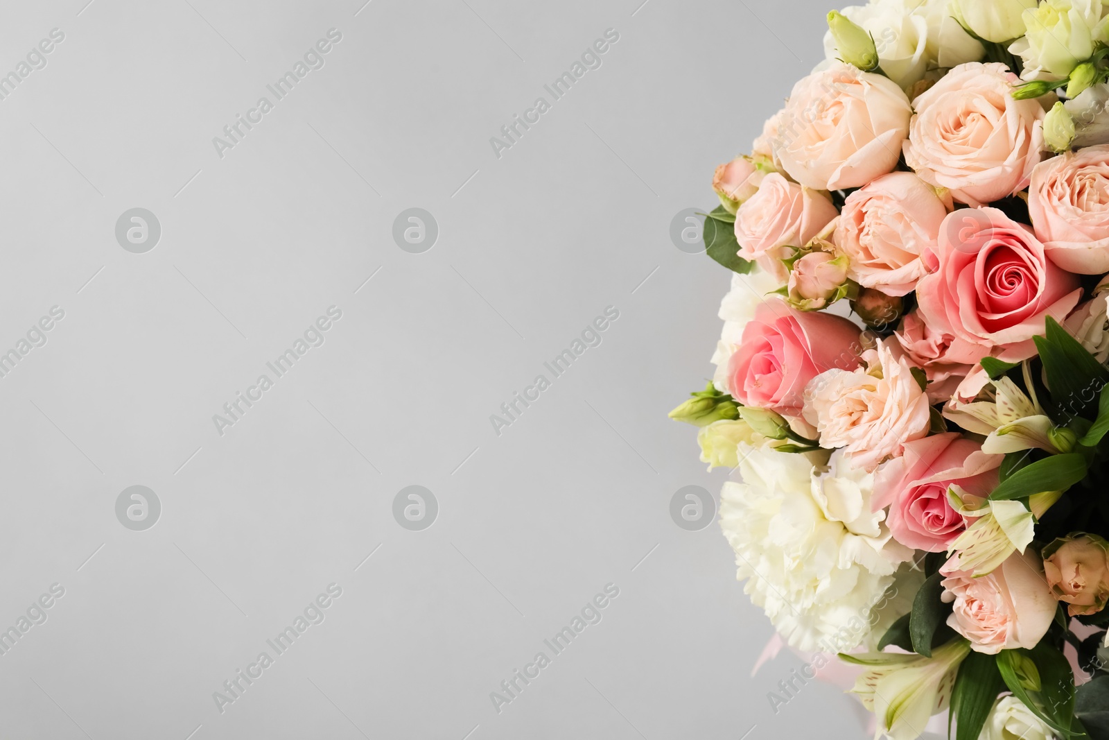 Photo of Bouquet of beautiful flowers on grey background, top view. Space for text