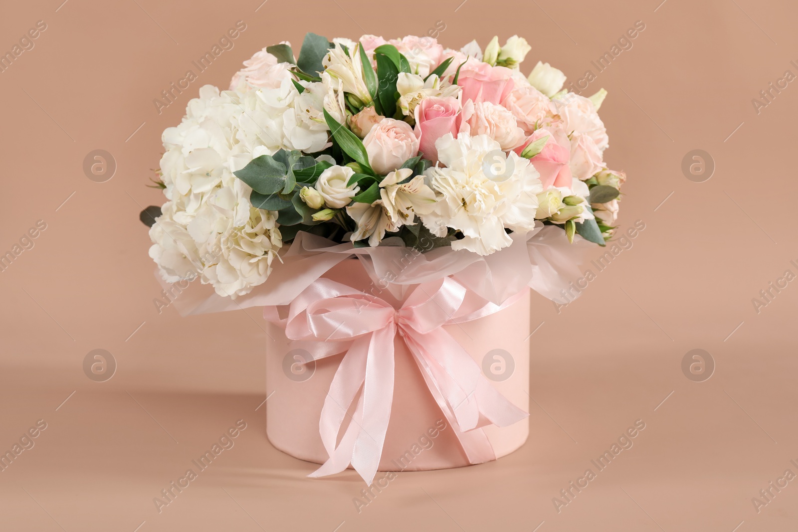 Photo of Bouquet of beautiful flowers on beige background