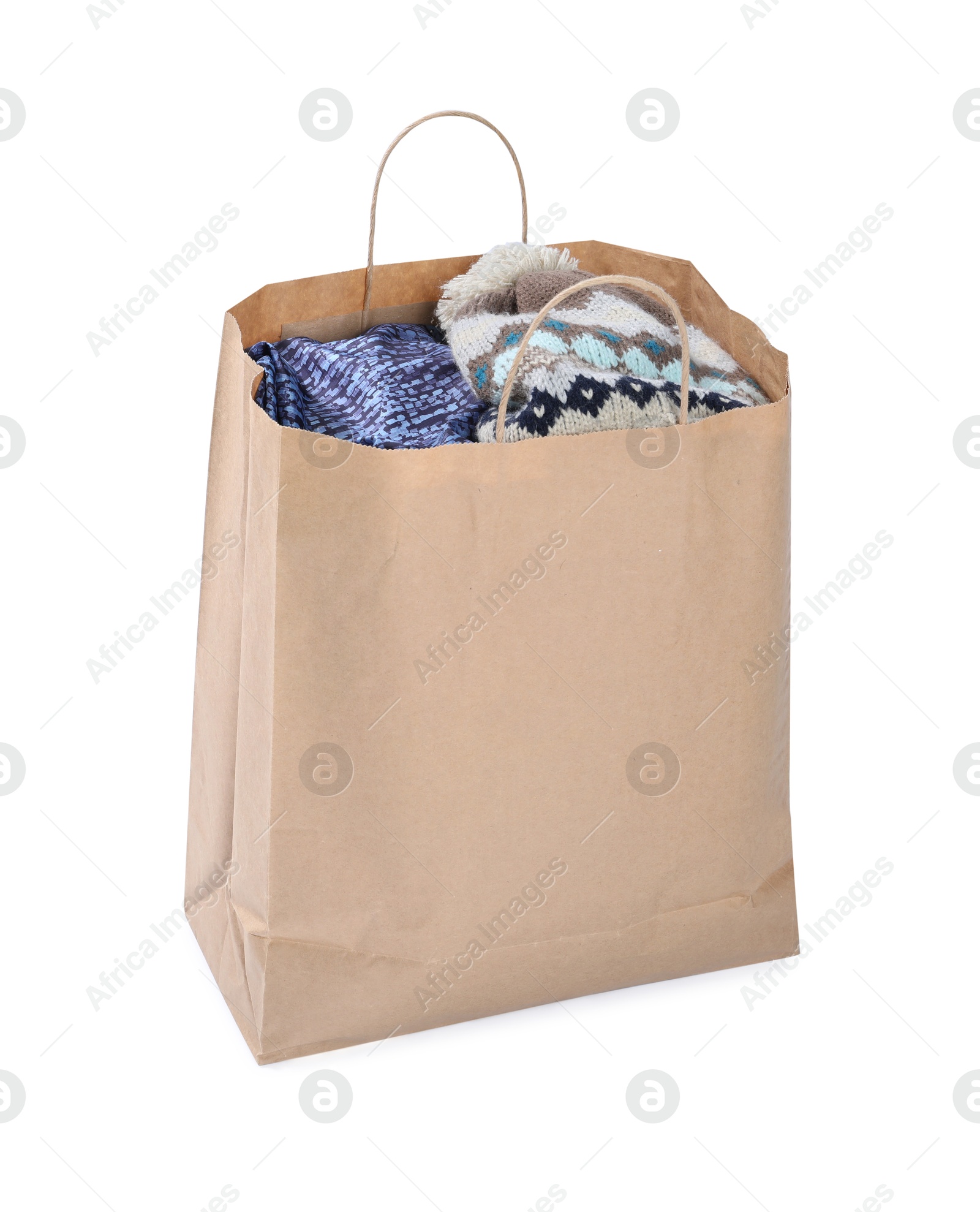 Photo of Used clothes in paper bag isolated on white