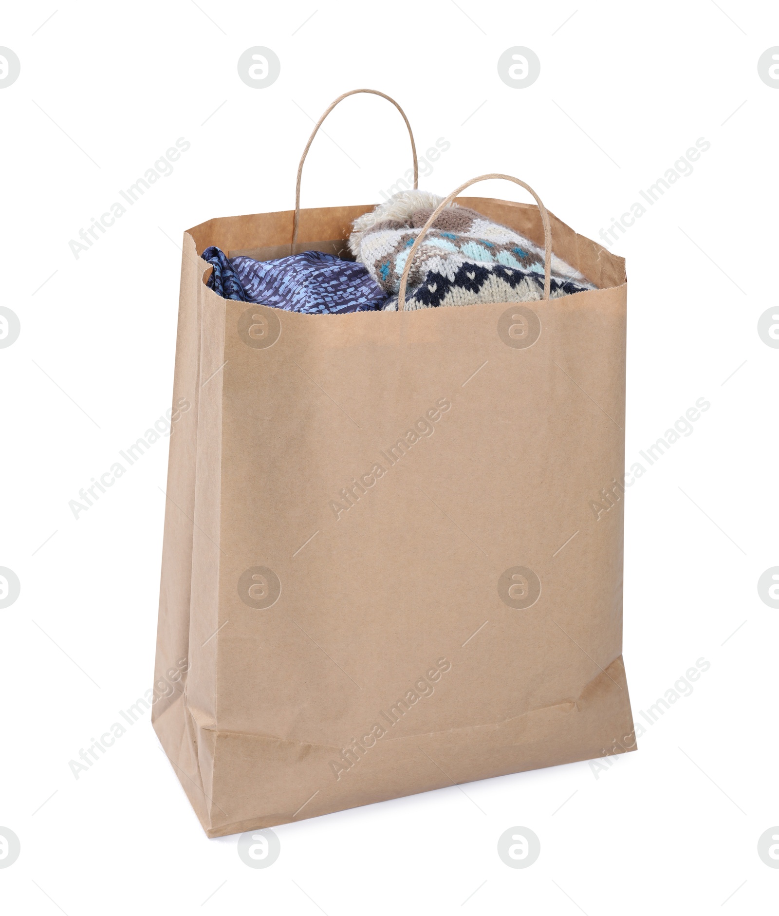 Photo of Used clothes in paper bag isolated on white