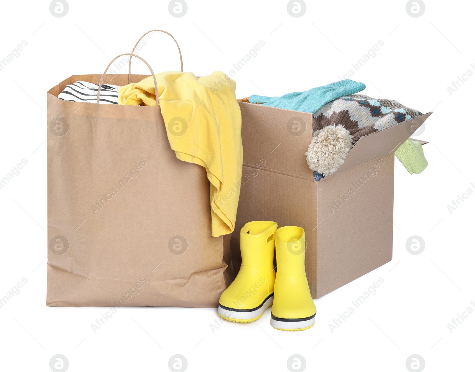 Photo of Packed used clothes and boots isolated on white