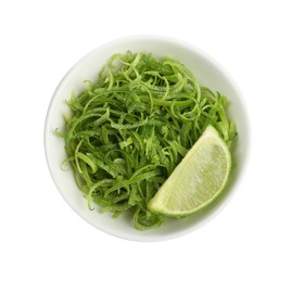 Photo of Lime zest and piece of fruit in bowl isolated on white, top view