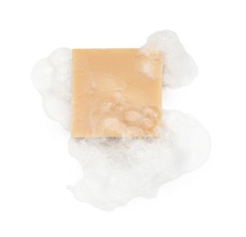 Photo of Beige soap with foam on white background, top view